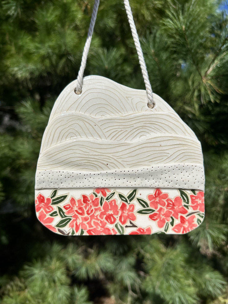 mountain wall hanging with sgraffito flowers